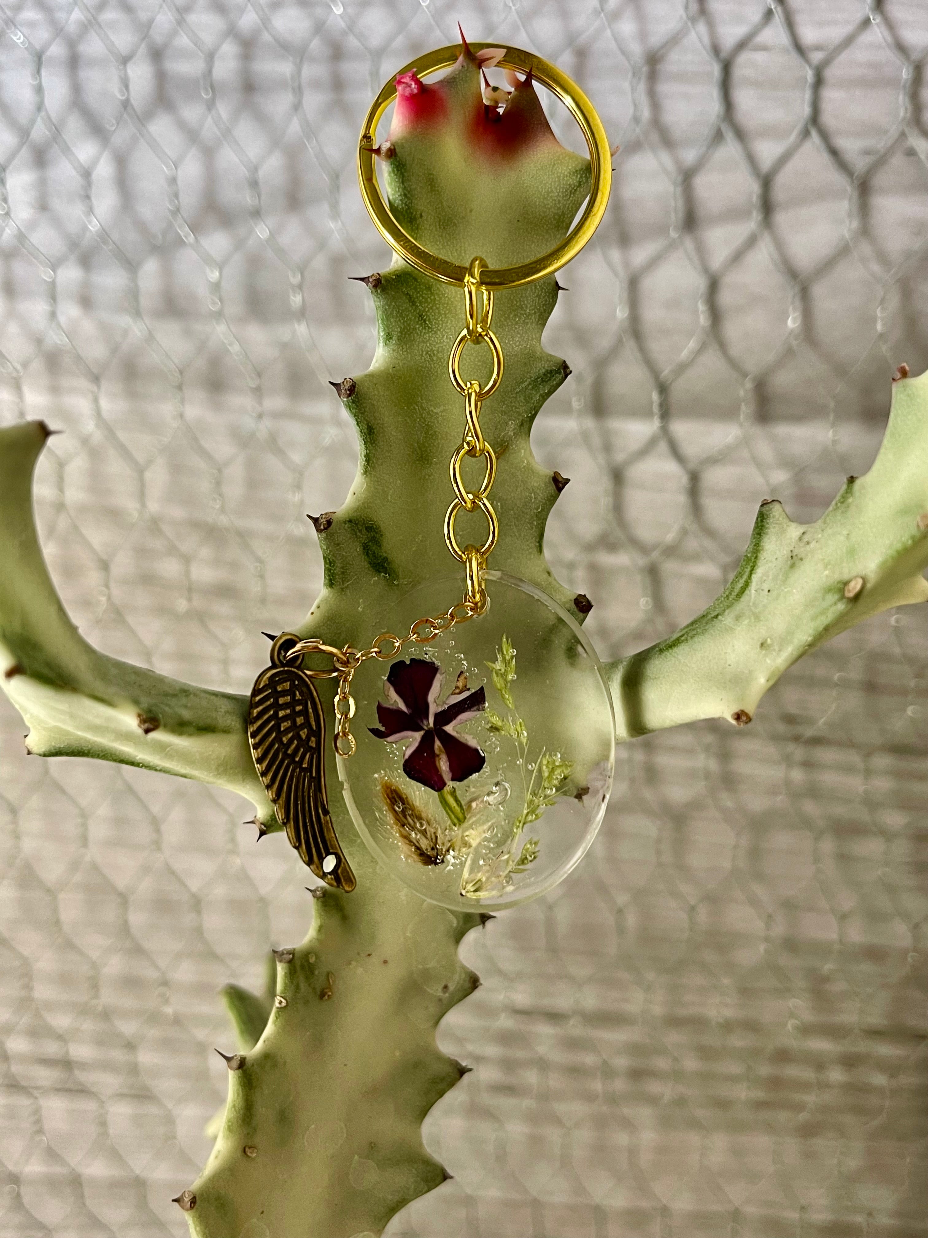 Resin pressed annual flower keychain with angel wing charm